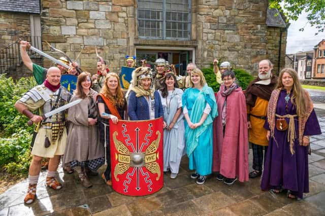 In Roman times the headgear worn by the lady behind the shield (scutum) would have been worn by the legion's aquilifer (or eagle standard bearer). Not many people know that.