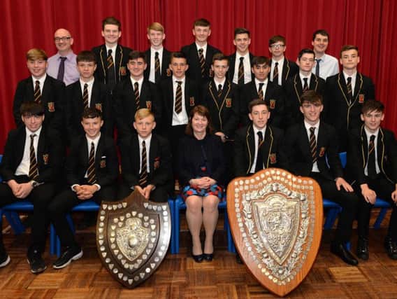 Braidhurst Highs Scottish Schools Cup under-16 and under-18 winners are pictured with co-manager Peter Brandon and headteacher Carolyn Rooney
