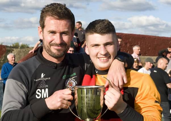 Keeper Jordan Brown celebrates with manager Stewart Maxwell after Rob Roy's Sectional League Cup win