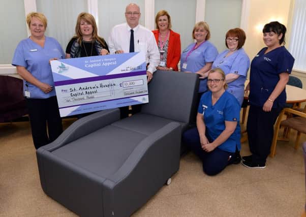 Forgewood Holdings chairman Charlie Millar flanked by St Andrews Hospices Karen McFadyen and Lorna McCafferty with some of the nursing staff
