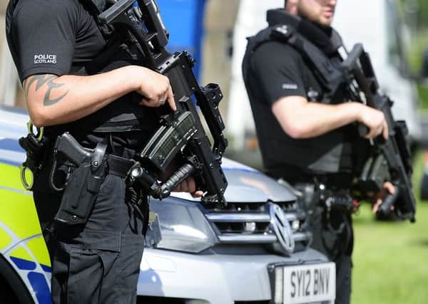 Armed police will remain at the Scottish Parliament
