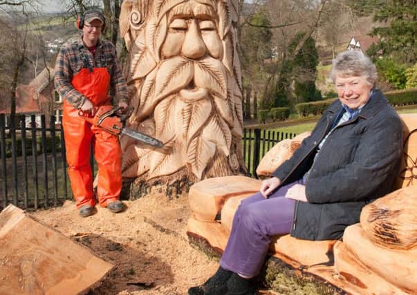 Sylvia Russell in Castlebank's fairy dell, while chainsaw sculptor Iain Chalmers was working on the carvings.  (Pic Sarah Peters)