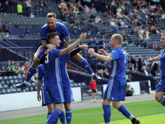 Jubilant Darren Miller jumps onto the shoulders of goalscoring hero Paul McLaughlin after the strike which secured Colville Parks second straight Scottish Amateur Cup final triumph at Hampden Park last month (Pic by Alan Watson)