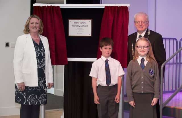 Head teacher Grace McGill and Depute Provost Pews, with pupils Sean and Hannah, unveil the plaque
