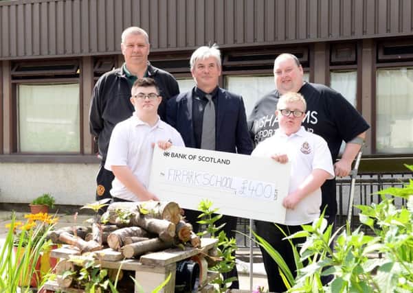 Firpark Secondary headteacher John Morley (centre) and pupils Cameron Docherty (front, left) and Reece Cooper with Motherwell Community Groups Scott Symington (left) and MS Society committee member James Jarvie. Pic: Alan Watson