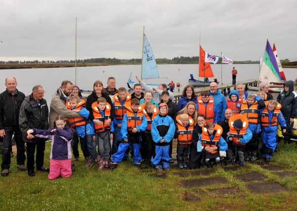 21-05-2017 Picture Roberto Cavieres. 
Cumbernauld Sailing Club, Fannyside Loch, Fannyside Rd, FK1 3DX. RYA Push the Boat Out Open Day with PALS group and others out on the water trying dinghies . Both Pals' childern and parents had a great day out. The club's satff with Joe Swierczek and and members made the preparations to receive the group. They sorted out the boats and the clothing gear for everybody. Then they were taken to the dock laden the kids on board and -away you go!!!. From the distance you can see how much the kids enjoyed the sailing, some of them could not hide their excitement. As if that was not enough then they went crazy splashing in the water. The clubs chairman is proud to show the  new certificate and flag of  Sailability.