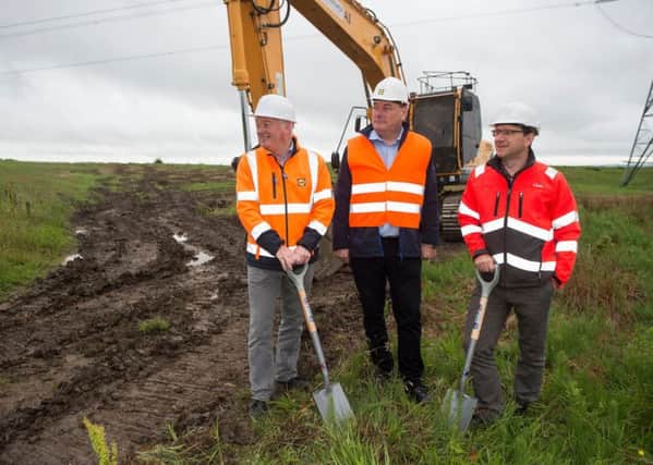 Lidls (l-r) Gordon Rafferty, Ross Millar and Graeme Mair cut the sod as work gets underway. Pic: Lenny Warren