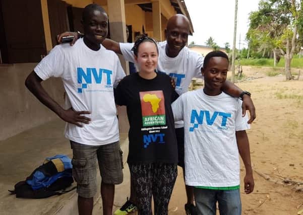 Mandy McCormick hangs out with some locals in Woe who are sporting t-shirts from her sponsor NVT Group