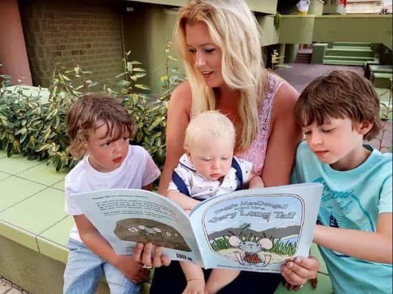 Kate reading her book about Haggis MacDougall the mouse to her children.