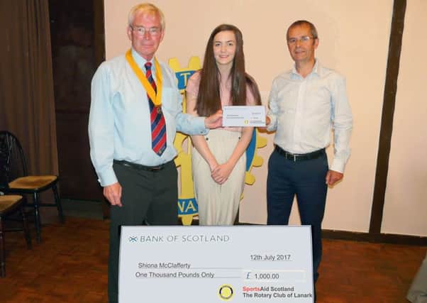Lanark Swimming Club's Shiona McClafferty (centre) receives a Â£1000 cheque from The Rotary Club of LanarkÂ’s Senior Vice President Neil Gainford and Roddy McKenzie of Sport Aid Scotland. The donation will support Shiona as she prepares to fly out to Turkey for The Deaflympics in Samsun, July 2017. (Submitted pic)