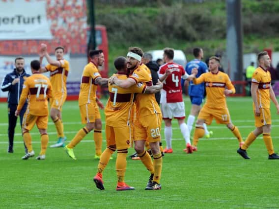 A bandaged Craig Clay celebrates with Lionel Ainsworth after Motherwell's vital 1-0 victory at Hamilton Accies towards the end of last season which helped keep the Steelmen up (Pic by Alan Watson)