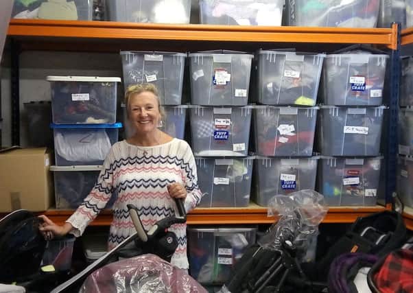 Bernadette Murphy, with some of the sorted goods ready to go out to families in despair.