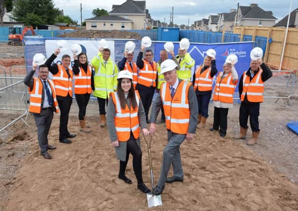Cutting the first sod are convener of Enterprise and Housing, Councillor Allan Graham and vice convener, Councillor Olivia Carson. Looking on are representatives from North Lanarkshire Council and Robertson Partnership Homes.