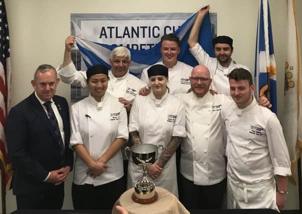 Russell, back right, celebrates the win with the team, and with Masterchef Gary Maclean front second right.