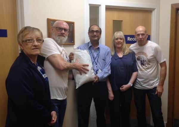 Project Gambias Frank Devine, second left, and Paul Lafferty, far right, take delivery of more hearing aids after meeting ear specialist Arun Iyer and his NHS colleagues