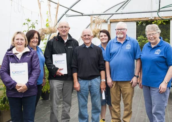Lanark in Bloom volunteers welcome the judges to the polytunnel where plants are brought on. (Picture Sarah Peters)