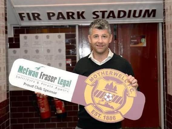 Motherwell gaffer Stephen Robinson shows his support for the club's main sponsor McEwan Fraser Legal