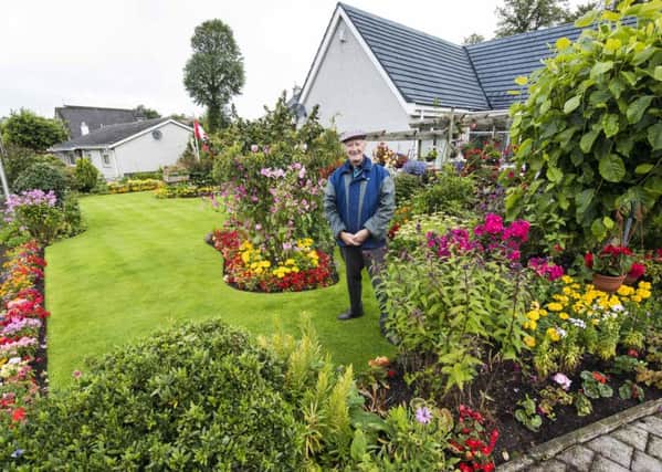 John Prior in his garden at Friarsfield Road, winning the large garden category. (Picture Sarah Peters).