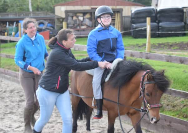 Pony lessons...are a breeze for Ben Ireland and his mum Louise, pictured here with Chico and Lee.
