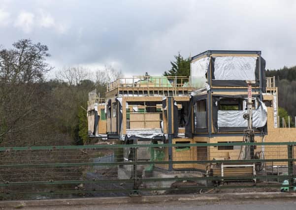 A house already granted permission is under construction at Crossford, although the site is currently hidden behind dark screens.