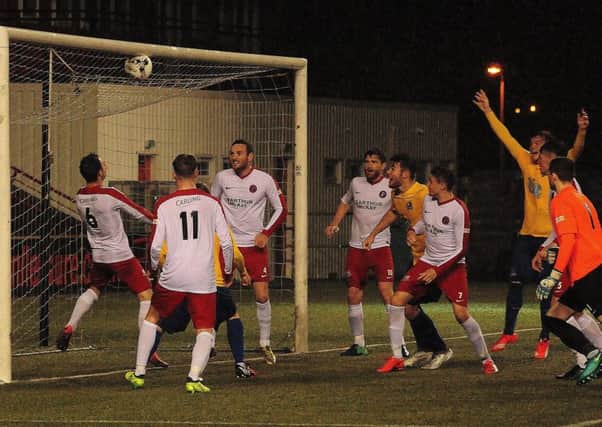 Sean Brown claims in vain that his header is over the Spartans line (pic by Alex Miller)