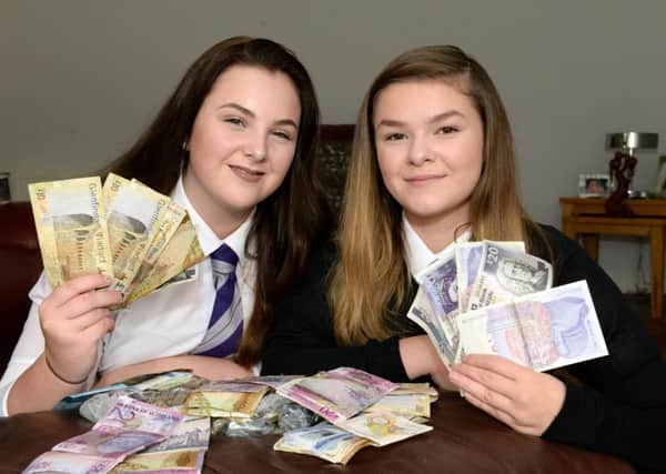 Lucy, left, and Sophie count the cash after their successful fundraiser