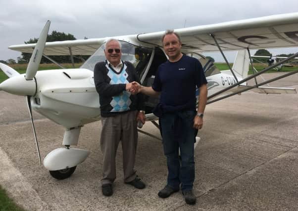 David Luke from Lanark, with his flying instructor Graham McNally.