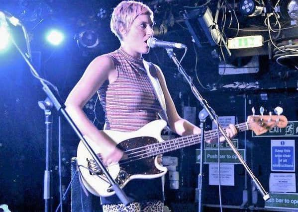 Jo D'Arc posted a picture of her playing the bass guitar that was stolen on her Facebook page