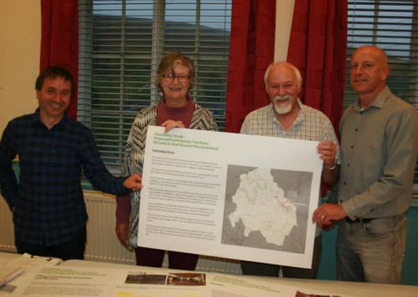 Mapped out - showing the buyout area are  Anjo Abelaira, vice chair of Wanlockhead  Trust; Claudia Beamish, MSP, Lincoln Richford, chair of the trust,  Richard Heggie, Founding Director of Urban Animation.
