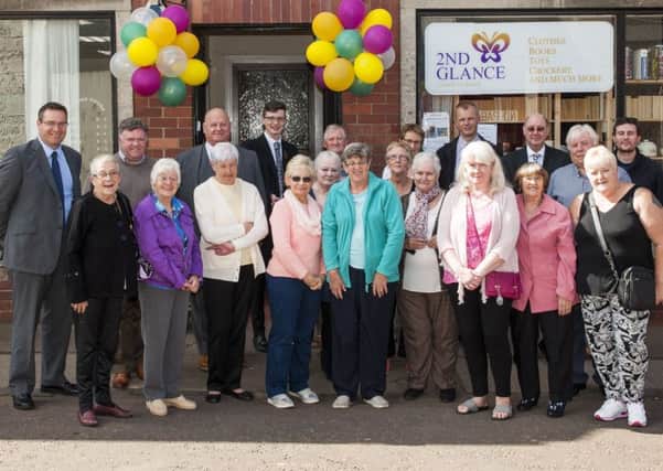 Charity shop Volunteers celebrate with local councillors, board members, Dave Knight from the Lottery and John Archibald from the Clyde Windfarm. Picture Sarah Peters.
