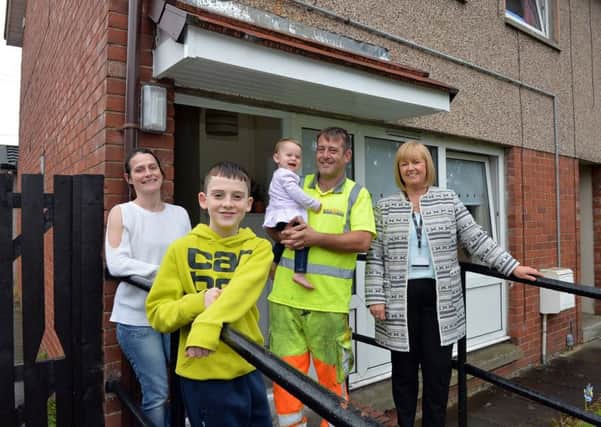 Empty Homes officer Catriona Arbuckle welcomes Thomas Stanfield, Fiona Kerr and their childrena into their new home after it was brought back into North Lanarkshire Council ownership