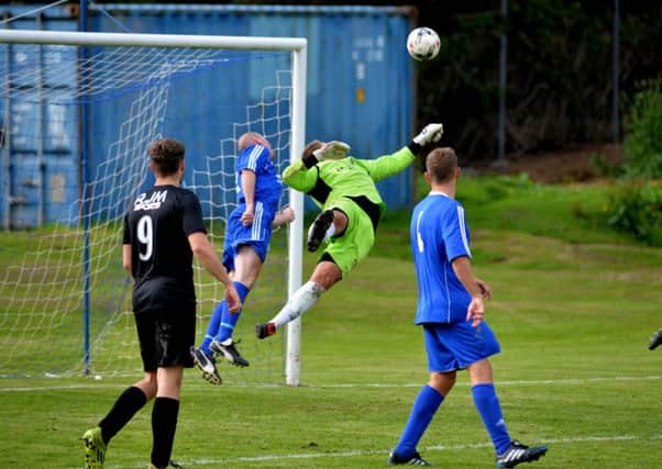 Sean Brown watches Hawick keeper Craig Saunders pull off a spectacular save