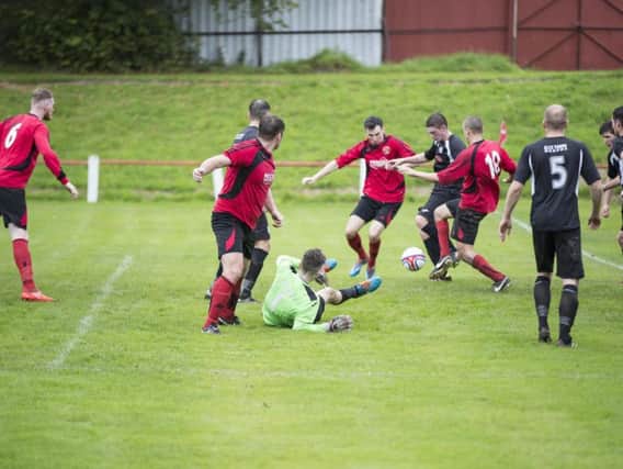 Some frantic action from what was a nine-goal thriller between Thorniewood United and Wishaw last Saturday (Pic by Karen Gordon)