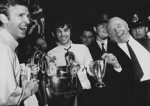 Sir Matt Busby shares his joy and the European Cup with Manchester United players Pat Crerand and George Best in 1968
