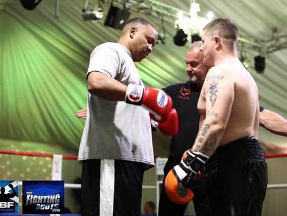 Two-time world heavyweight boxing champion Tim Witherspoon (59) squares up to local man Steven McGhee before their recent exhibition fight (Submitted pic)