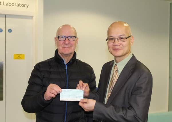 (L-R) Ralph Halley presents cheque to Hing Leung, Professor of urology and surgical oncology.