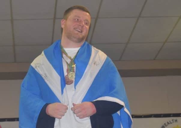 Bearsden powerlifter Mark Macqueen on the podium after adding the Commonwealth championship to his World and European titles