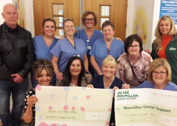The family of Angie Passmore present cheques to Michaelle Campbell of Macmillan Cancer Support and staff from the  neonatal unit at Wishaw General Hospital
