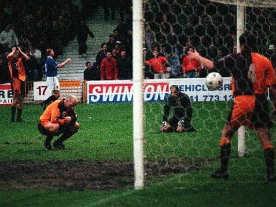 Brian Martin hangs his head in despair after a blunder by Motherwell keeper Stevie Woods let in Rangers striker Gordon Durie to make it 2-2 with just seven minutes remaining of the sides Scottish Cup fourth round tie at Fir Park in February 1998. The Glasgow giants won 3-0 in the replay.