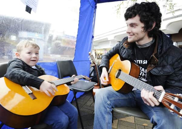 Kade Kennedy-Clayton learns the guitar from Jordan Milligan


at last year's event