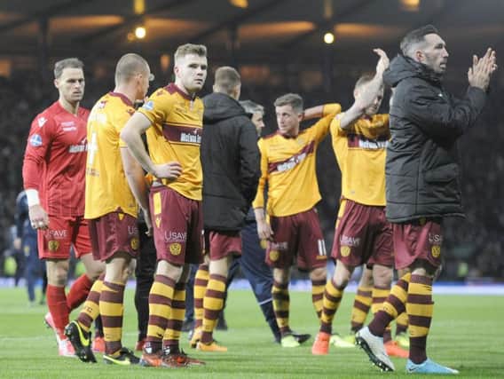 A dejected Chris Cadden (third left) and his Motherwell team-mates on the Hampden pitch after Sunday's Betfred Cup final defeat (Pic by Michael Gillen)