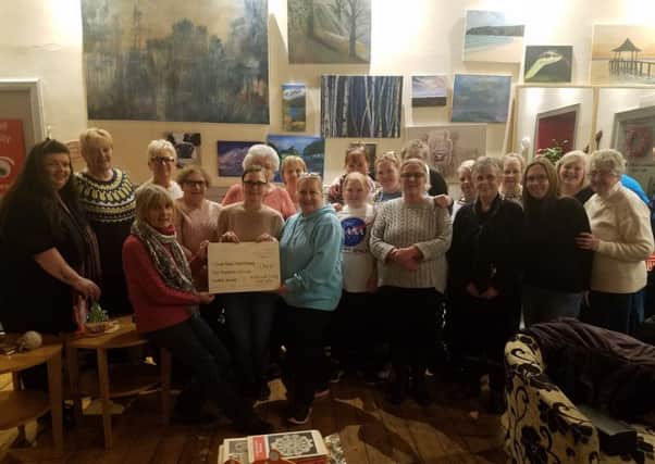 Motherwell Crafty Knit-Wits present the cheque for Â£1900 to South Dalziel Historic Building managing director Moira Harvey
