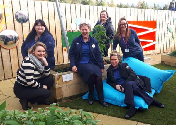 Clare Cogan Turner (SBH Comms Manager); Jackie Rocks (Craigmarloch Tesco); Doreen Reid (Community Champion Craigmarloch Tesco);  Gillian Riley (Cumbernauld Tesco); Allana Morrison (Community Champion Cumbernauld Tesco); Vikki Rothero (SBH Family Support Worker) as commemorative plaque has been unveiled at the new Bee and Butterfly Sensory Garden in Dullatur.