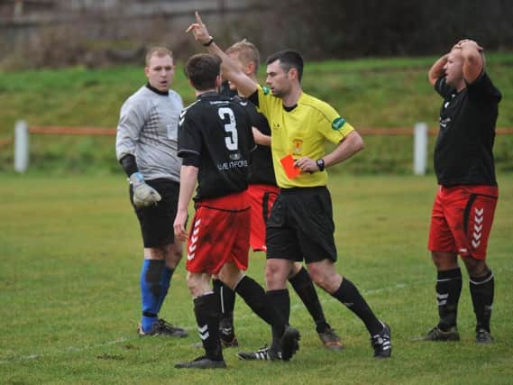 East Kilbrides Callum McLean receives a straight red card for handball against Thorniewood (Pic by Angie Isac)