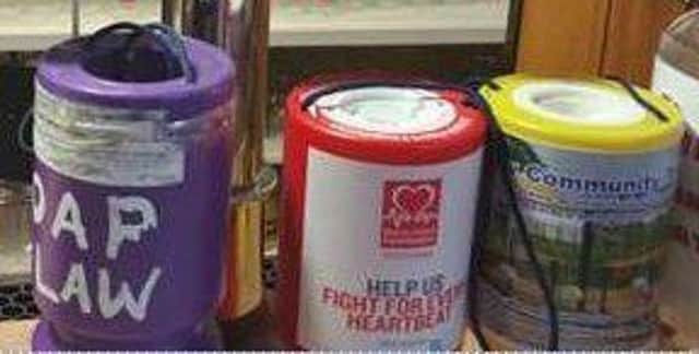 Charity tins stolen in Law armed robbery. Photo Anita Collins.