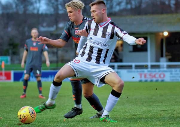 Brian Cameron shields the ball from Clyde's Tom Lang (pic by Robert W Crombie).