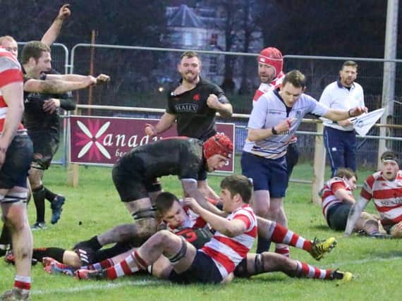 Ryan Moffat has just scored the second of Biggars tries and as he gets up his team mates celebrate (Pic by Nigel Pacey)
