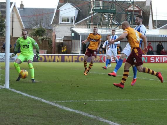 Kilmarnock's Kirk Broadfoot heads against his own post during Saturday's clash with Motherwell at Fir Park (Pic by Ian McFadyen)