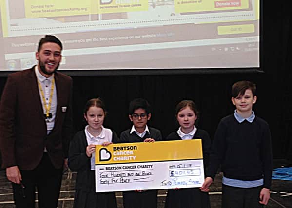 The pupils presented Calum McNair from the Beatson Cancer Charity with the cheque.