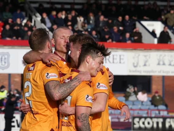 Motherwell players celebrate after the first half goal by Craig Tanner (1st right) at Dens Park on Saturday (Pic by Ian McFadyen)